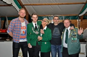 Fröhliche Mitglieder des Sebastianus & Afra Schützenbruderschaft beim Fest im Festzelt, zusammen lachend und in Uniformen mit Orden und Medaillen.
