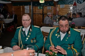 Traditionelle Schützenbrüder in grünen Uniformen bei einem Fest im Festzelt in Köln.